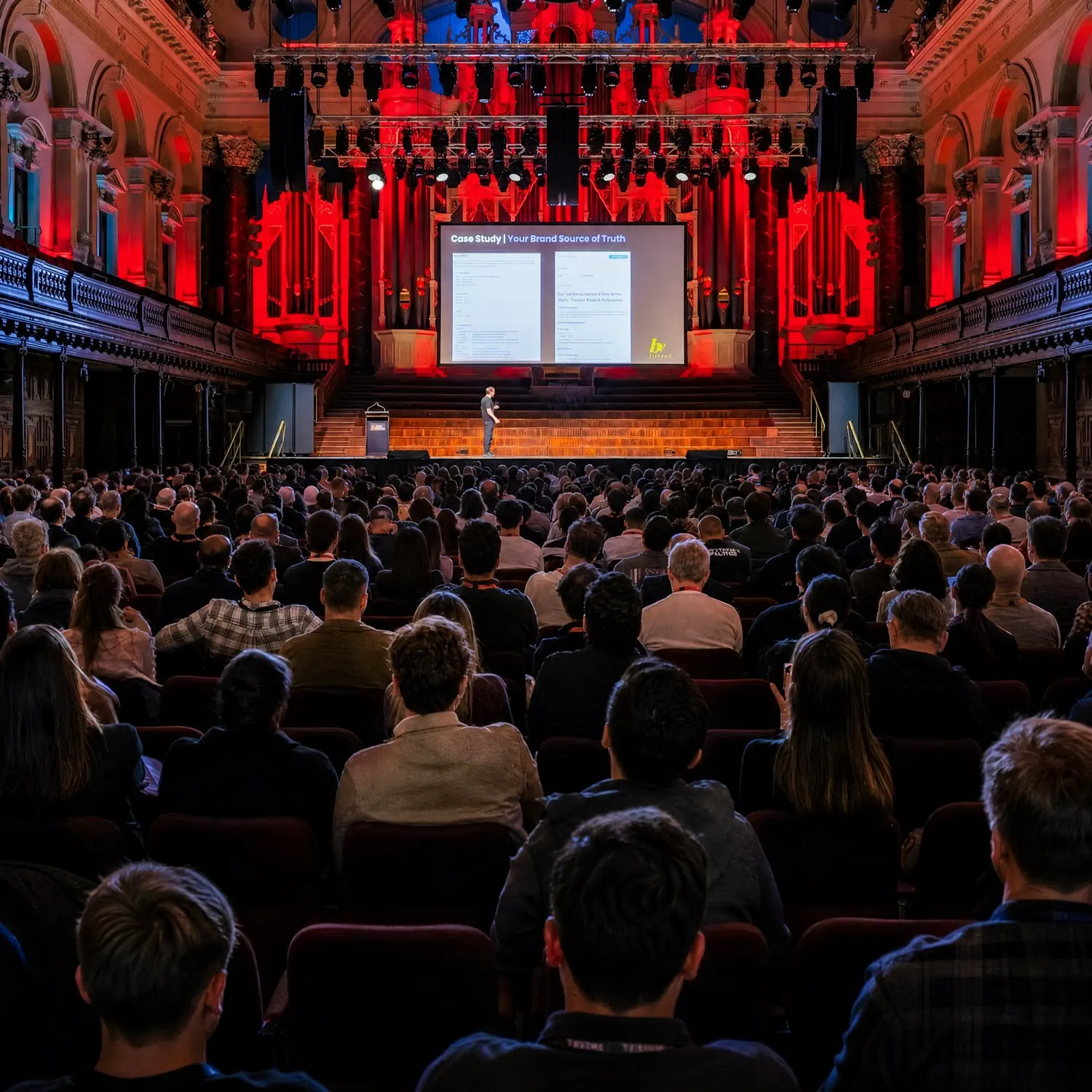 A speaker presenting to the Open Summit audience in Sydney Town Hall.