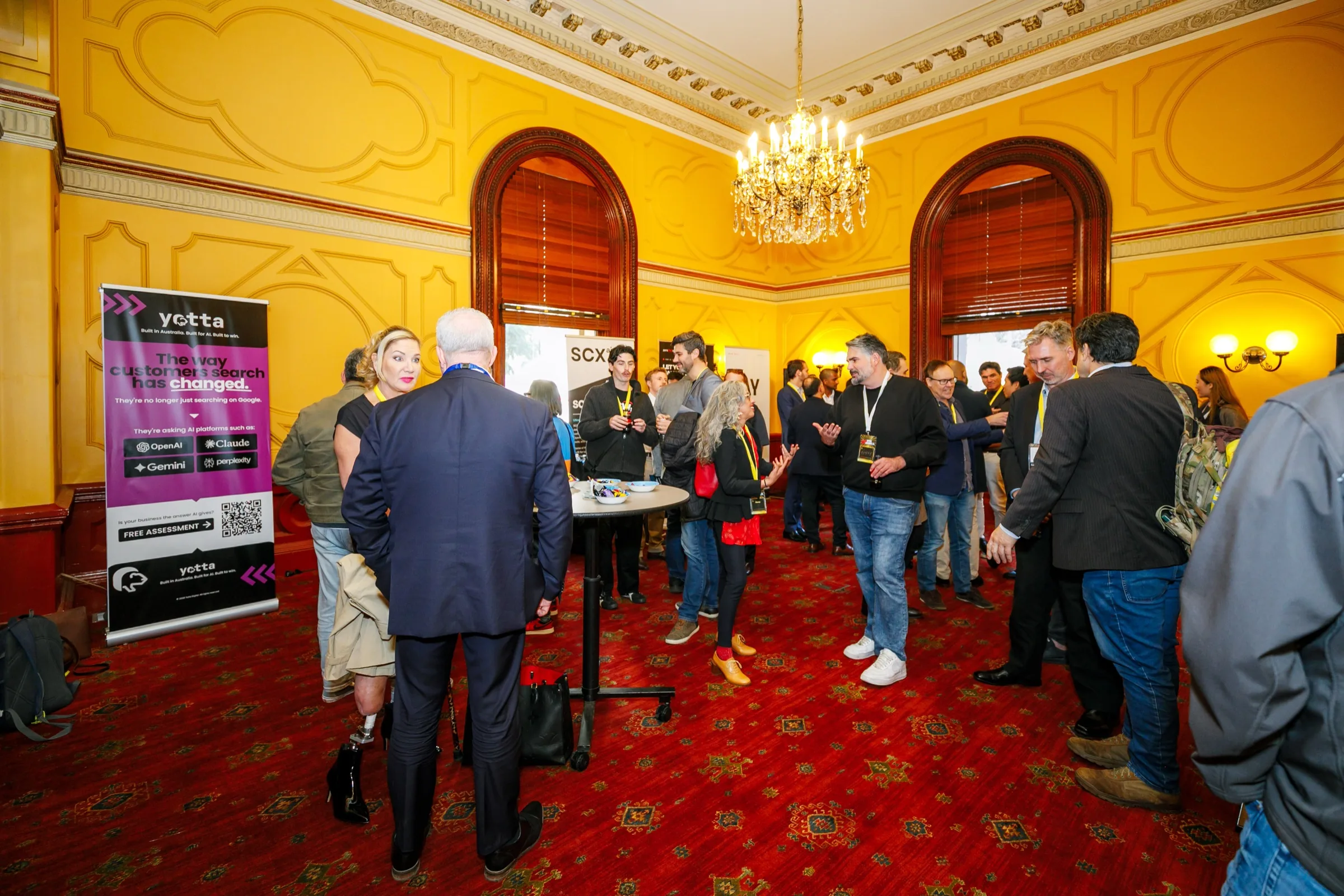 Attendees meeting and talking in the Open Summit reception room.