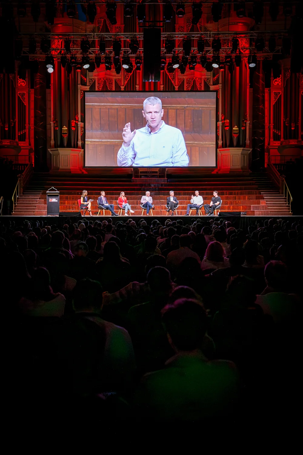 The audience and panel viewed from the rear seats at Open Summit in Sydney Town Hall.